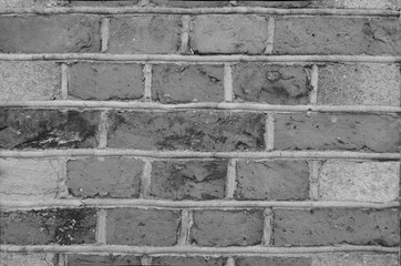 The texture of the bricks. Black and white.