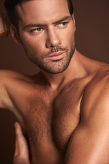 Model posing of young muscular naked man