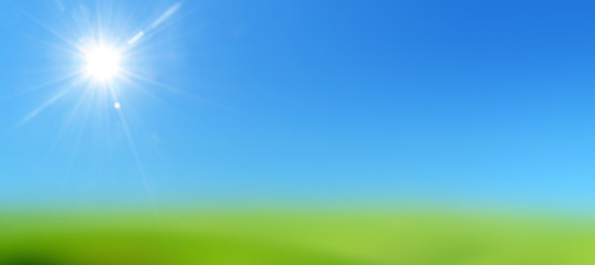 Fototapeta na wymiar blue sky with sun on a lawn of green grass 