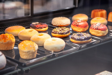 Multicolored donuts in shop window