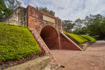 Fototapeta na wymiar Beautiful red brick tunnel scenic of the Eternal golden castle. Ruins of a defensive castle built with cannon in Tainan city, Taiwan.