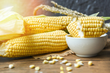 Fresh corn on cobs and sweet corn ears   on rustic wooden table background