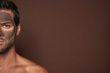 Half face portrait of manful guy with face mask