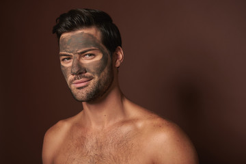 Young manful self-confident guy with face mask