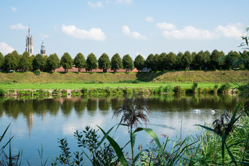 skyline of Hulst with water and Sint Willibordus Basilica, The Netherlands