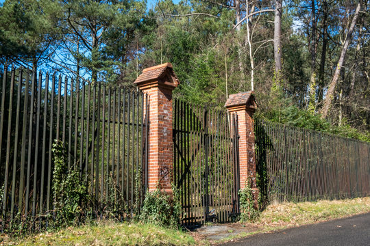 Old metal railings and gate with brick pillars