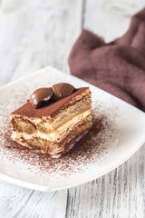 Portion of tiramisu on the white plate