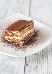 Portion of tiramisu on the white plate