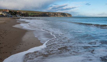 Groins and sea surf on a pebble beach