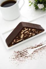 Cake slice, white porcelain coffee cup, white background, white flowers, cacao, fork shaped, white table top, close up, macro shot