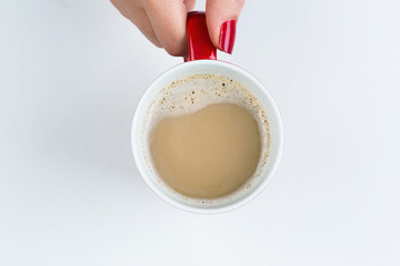 Female hand holding coffee on white background aerial view