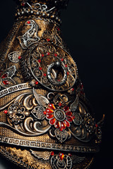 Head of mannequin in decorated fantasy hat, dark studio background