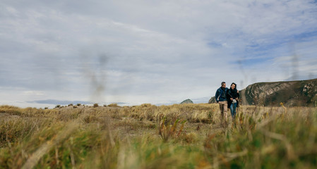 Young couple embraced taking a walk near the coast