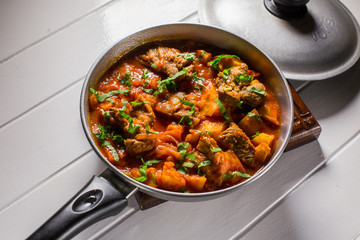 Stuffed meat with potatoes in a tomato sauce on a boiler