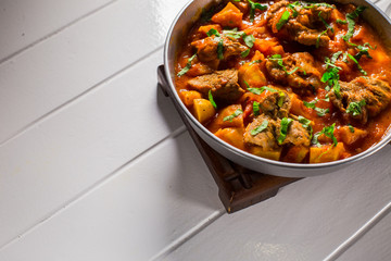 Stuffed meat with potatoes in a tomato sauce on a boiler
