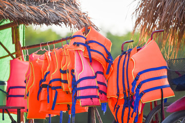 Colorful life jacket safety equipment on bamboo rail