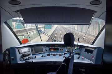 Empty train cabin of driver. Interior of control place of train standing on railway station....