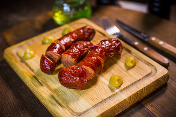 Fried sausage in a frying pan, with herbs and spices.