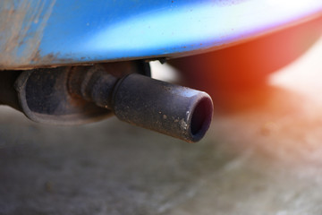Exhaust pipe on old car close up / Car pollution concept