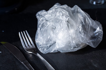 close up view on a crumpled plastic bag as a dish plate, image topic is for environment plastic polution