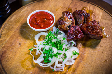Barbecue skewers with juicy meat and sauce on plate, closeup