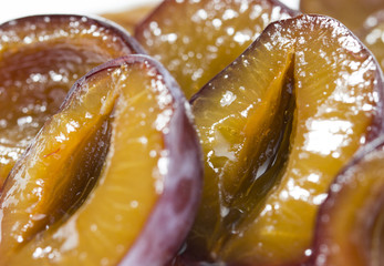 macro closeup of slice of juicy delicious ripe plum. fresh and frozen berries concept .
