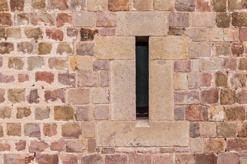 A window on the stone facade of the Montjuic Castle front view, Barcelona, Spain