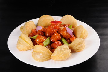 fried potatoes with meat and vegetables on plate