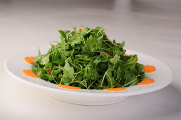 fresh green salad in a bowl isolated on white