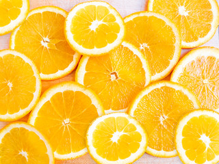 Close-up photo of fresh slised orange on a wooden background.