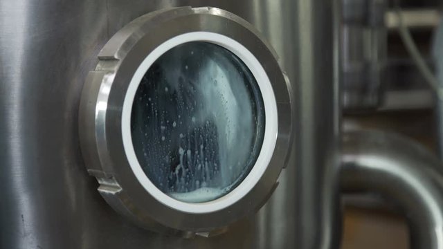 Pipeline at dairy factory. Huge cisterns for storing and fermenting milk. Equipment at dairy plant.