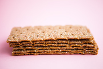 Crisp bread on the pink background