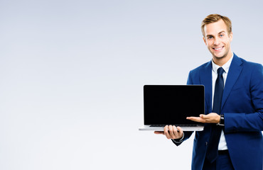 Businessman showing blank laptop