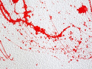 red blot and splatter paint on white background
