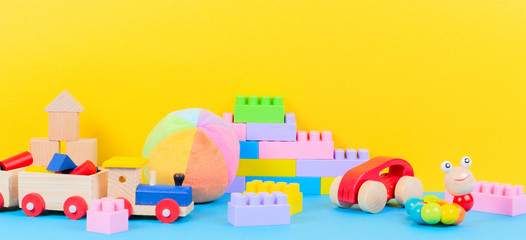 Baby kid toys collection on blue and yellow background