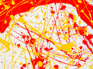 splashes of red and yellow paint on a white background