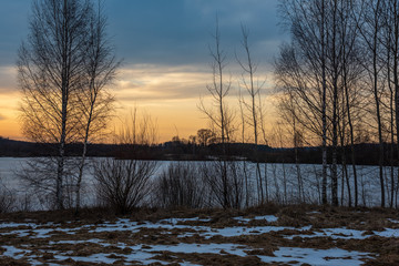 orange red sunset in winter in woods
