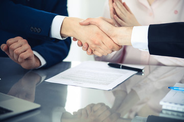 Business people shaking hands finishing up a meeting. Handshake at successful negotiation