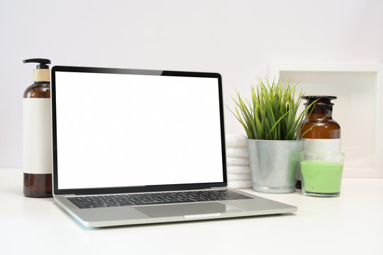 Blank screen laptop on spa table