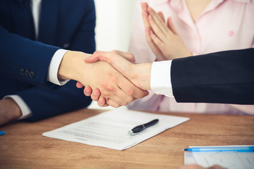 Business people shaking hands finishing up a meeting. Handshake at successful negotiation