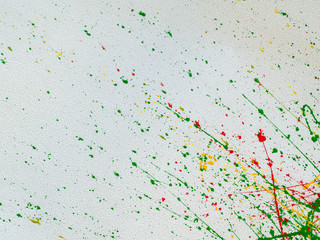 splashes of red and yellow green paint on a white background