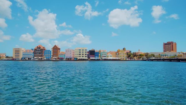 Rising shot revealing the ocean and beautiful world heritage buildings of Willemstad in Curacao, Caribbean
