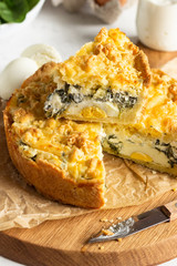 Tart or pie with spinach, ricotta and eggs.  Torta Pascualina, typical Italian Easter food. Light grey background. Copy space.