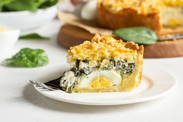 Tart or pie with spinach, ricotta and eggs.  Torta Pascualina, typical Italian Easter food. Light grey background. Copy space.