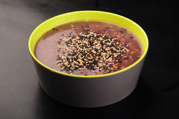 black sesame seeds in a bowl isolated on white