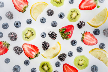 Fresh berries pattern - blueberries, strawberries, blackberries. On white background, top view, flatlay layout