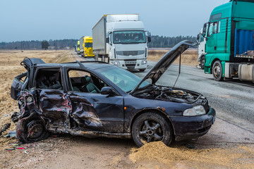 Car accident of three vehicles on a road in  car after a collision with a heavy truck, in Latvia