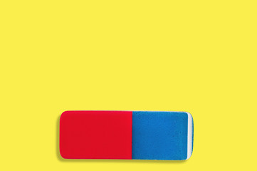 Single rectangular rubber eraser for pencil and pen ink on yellow background with copy space for your text