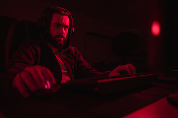 Bearded hacker using computer