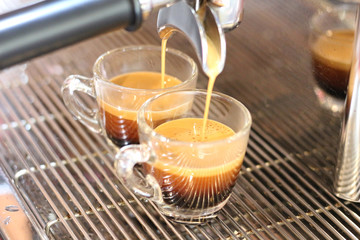 Black coffee being brewed by the machine